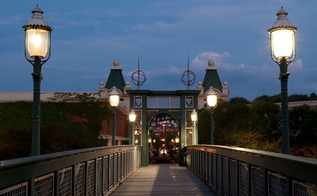 walkway of gas lamp posts at dusk